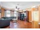 Open living space featuring hardwood floors, a ceiling fan, and a cozy dark gray sofa at 20427 Carolina Cherry Ct, Tampa, FL 33647