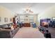Spacious living room with cozy seating, a ceiling fan, and carpeted floors at 20427 Carolina Cherry Ct, Tampa, FL 33647
