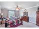 Comfortable main bedroom with a ceiling fan, crown molding, and a cozy atmosphere at 20427 Carolina Cherry Ct, Tampa, FL 33647