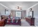Comfortable main bedroom with a ceiling fan, crown molding, and a cozy atmosphere at 20427 Carolina Cherry Ct, Tampa, FL 33647