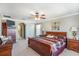 Comfortable main bedroom with a ceiling fan, crown molding, and neutral walls at 20427 Carolina Cherry Ct, Tampa, FL 33647