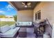 Cozy covered patio with outdoor seating and a built-in grill, perfect for entertaining at 20427 Carolina Cherry Ct, Tampa, FL 33647