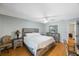 A bedroom with a neutral color palette and wooden furniture at 215 Valencia Blvd # 205, Belleair Bluffs, FL 33770