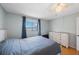 This bedroom features wood-look floors, natural light, and neutral tones at 215 Valencia Blvd # 205, Belleair Bluffs, FL 33770