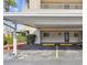 Assigned covered parking space with landscaping and easy access to the building at 215 Valencia Blvd # 205, Belleair Bluffs, FL 33770