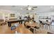 Spacious community room with pool table, seating, kitchen area, and fitness equipment at 215 Valencia Blvd # 205, Belleair Bluffs, FL 33770