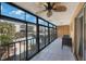 Relax in this airy lanai with floor-to-ceiling windows overlooking a pool and palm trees at 215 Valencia Blvd # 205, Belleair Bluffs, FL 33770