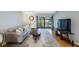 Bright living room with a comfortable sofa and balcony access, perfect for relaxation at 215 Valencia Blvd # 205, Belleair Bluffs, FL 33770