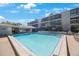 Community pool featuring clear water, palm trees and plenty of room to relax at 215 Valencia Blvd # 205, Belleair Bluffs, FL 33770