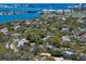 Picturesque aerial view of a waterfront community with lush greenery and city skyline at 217 Manatee Rd, Belleair, FL 33756