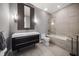 Modern bathroom with sleek vanity, oversized mirror, and tiled shower-over-tub at 217 Manatee Rd, Belleair, FL 33756