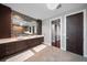 Modern bathroom boasts double sinks, an oversized mirror, and stylish lighting with dark wood cabinets at 217 Manatee Rd, Belleair, FL 33756