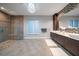 Bright bathroom featuring a glass enclosed shower, double sinks, and mosaic tile accents at 217 Manatee Rd, Belleair, FL 33756