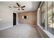 Bedroom features a decorative wall, ceiling fan and bright windows with a lush view at 217 Manatee Rd, Belleair, FL 33756