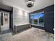 Stylish room featuring built-in desk and shelving units, complemented by modern light fixture and a large window at 217 Manatee Rd, Belleair, FL 33756