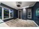 Stylish room featuring navy walls with decorative wall trim, complemented by modern light fixture and two windows at 217 Manatee Rd, Belleair, FL 33756