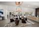 Dining room boasts a large chandelier and a table with modern chairs and view of the pool at 217 Manatee Rd, Belleair, FL 33756