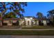 Stunning exterior of this well maintained home with mature landscaping and a stone entryway at 217 Manatee Rd, Belleair, FL 33756