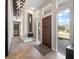 Welcoming foyer featuring modern light fixtures, hardwood floors, high ceilings, and a beautiful entryway at 217 Manatee Rd, Belleair, FL 33756