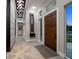 Inviting foyer with modern finishes, hardwood floors, designer lighting, and custom wall accents at 217 Manatee Rd, Belleair, FL 33756