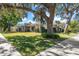 Home exterior featuring lush lawn and mature oak trees, enhancing curb appeal at 217 Manatee Rd, Belleair, FL 33756