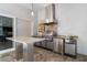 A luxurious outdoor kitchen features stainless steel appliances, granite countertops, and a modern design perfect for entertaining at 217 Manatee Rd, Belleair, FL 33756