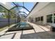 Relaxing outdoor space features a sparkling pool with a screened enclosure and large deck at 217 Manatee Rd, Belleair, FL 33756