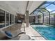 Enjoy outdoor living with this screened pool, complete with a spa, lounge area, and seamless transition to the home's interior at 217 Manatee Rd, Belleair, FL 33756