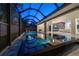 Relax by the sparkling screened pool and spa area with seamless indoor-outdoor living, perfect for those hot summer evenings at 217 Manatee Rd, Belleair, FL 33756