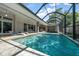 Enjoy this sparkling screened pool area, featuring a jacuzzi, comfortable lounge chairs, and ample space for entertainment at 217 Manatee Rd, Belleair, FL 33756