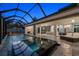 The tranquil screened pool and spa area features seamless indoor-outdoor living and a modern design, perfect for relaxing evenings at 217 Manatee Rd, Belleair, FL 33756