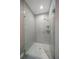 Sleek glass-enclosed shower with subway tile walls, mosaic tile floor, and modern fixtures at 217 Manatee Rd, Belleair, FL 33756