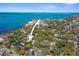 Aerial view of property nestled in a tree-lined neighborhood near the water at 235 Aberdeen St, Dunedin, FL 34698