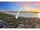 Aerial view of the property surrounded by trees, showcasing its proximity to the water at 235 Aberdeen St, Dunedin, FL 34698