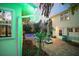 Scenic backyard featuring a pool, tiki bar, and colorful patio furniture, perfect for outdoor gatherings at 235 Aberdeen St, Dunedin, FL 34698