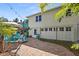 Backyard patio with a tiki bar and outdoor seating, perfect for entertaining by the pool at 235 Aberdeen St, Dunedin, FL 34698