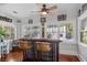 Bright bar area with seating, ceiling fan, and multiple windows at 235 Aberdeen St, Dunedin, FL 34698