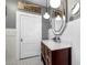 Bathroom vanity with marble countertop and a modern, geometric mirror at 235 Aberdeen St, Dunedin, FL 34698