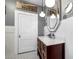 A bathroom with a dark wood vanity, marble countertop, modern lights, and contrasting black and white tile at 235 Aberdeen St, Dunedin, FL 34698