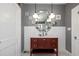 Charming bathroom featuring a dark wood vanity with a marble countertop and modern lighting fixtures at 235 Aberdeen St, Dunedin, FL 34698