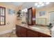 Bathroom featuring double sinks, granite countertops, and built in shelving at 235 Aberdeen St, Dunedin, FL 34698