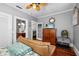 Bedroom featuring wood floors, a brown leather sofa and ensuite bathroom at 235 Aberdeen St, Dunedin, FL 34698