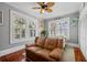 Bedroom with light gray walls, wood floors, and a brown leather sofa at 235 Aberdeen St, Dunedin, FL 34698