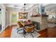 Dining room featuring a stone fireplace, unique wooden table, and coffered ceilings at 235 Aberdeen St, Dunedin, FL 34698