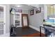 Home office with gray walls, black floors and a wall mounted TV at 235 Aberdeen St, Dunedin, FL 34698