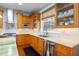 Kitchen featuring stainless steel appliances, wood cabinets, tiled backsplash, and countertops at 235 Aberdeen St, Dunedin, FL 34698