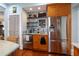 Kitchen area featuring a wet bar, stainless steel refrigerator and stainless steel freezer and wood cabinets at 235 Aberdeen St, Dunedin, FL 34698