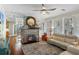 Inviting living room featuring a stone fireplace, white sofa, and rustic decor, creating a warm and welcoming space at 235 Aberdeen St, Dunedin, FL 34698