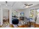 Comfortable living room with work desk and a TV, complete with coastal decor at 235 Aberdeen St, Dunedin, FL 34698