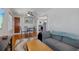 Cozy living room with hardwood floors and blue couch leading to kitchen area at 235 Aberdeen St, Dunedin, FL 34698